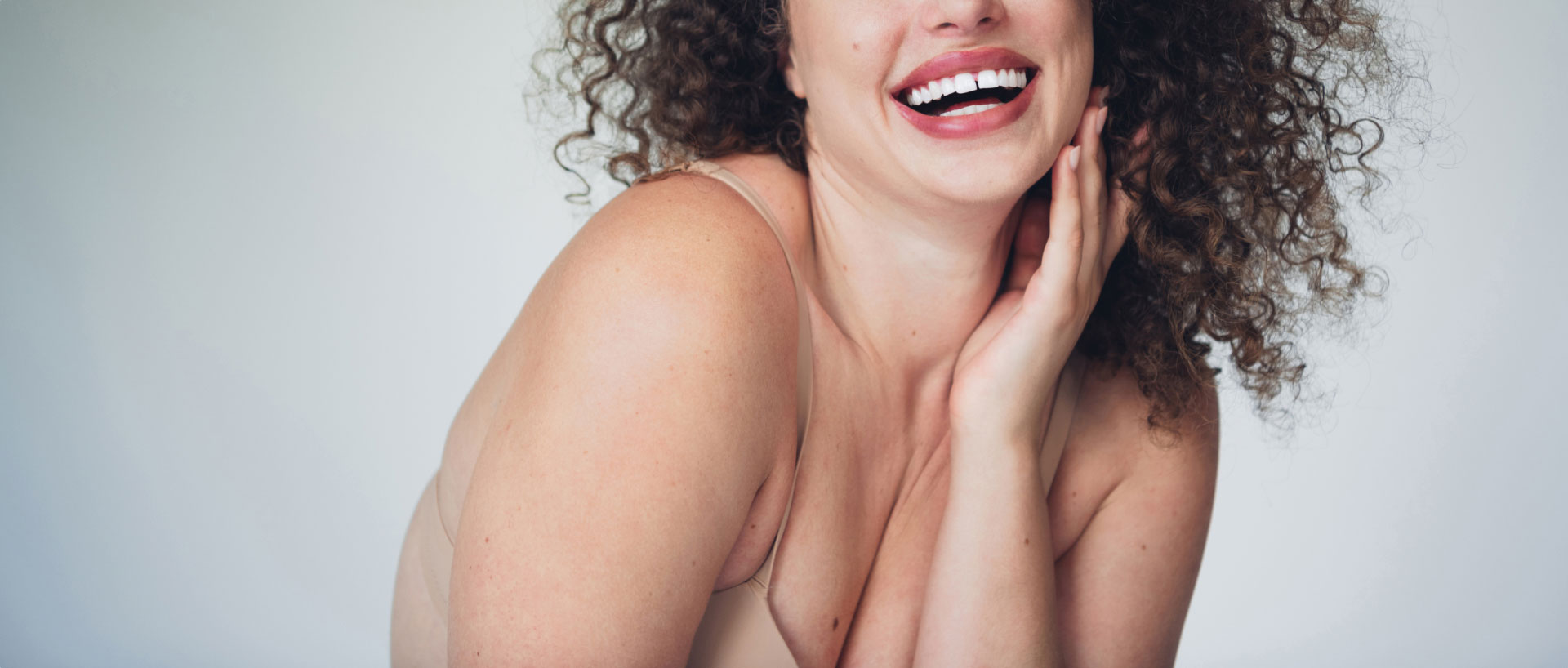 chicago breast lift model with dark curly hair